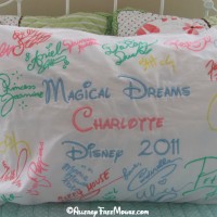 Disney character autographs on a pillow